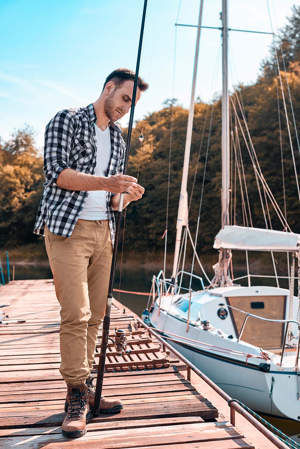 young-man-preparing-his-fishing-rod-MTH5KA6-resize.jpg